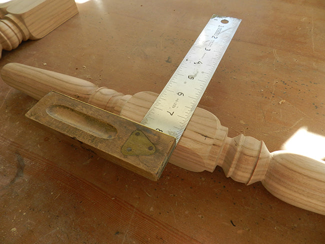 Marking a line with a set square to indicate the location of the lower rail on the leg work piece used to build the stool frame assembly