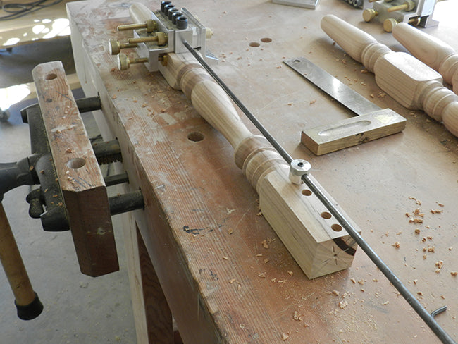 Dowelmax device aligned with extended distance gauge to drill the lower rail to leg joint used to build the stool frame assembly