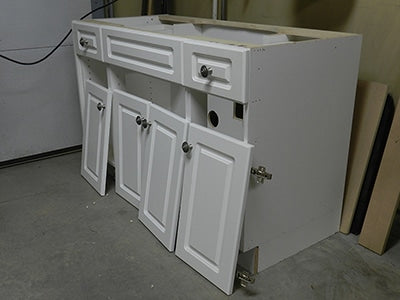 Bathroom vanity cabinet before, rebuilt in article