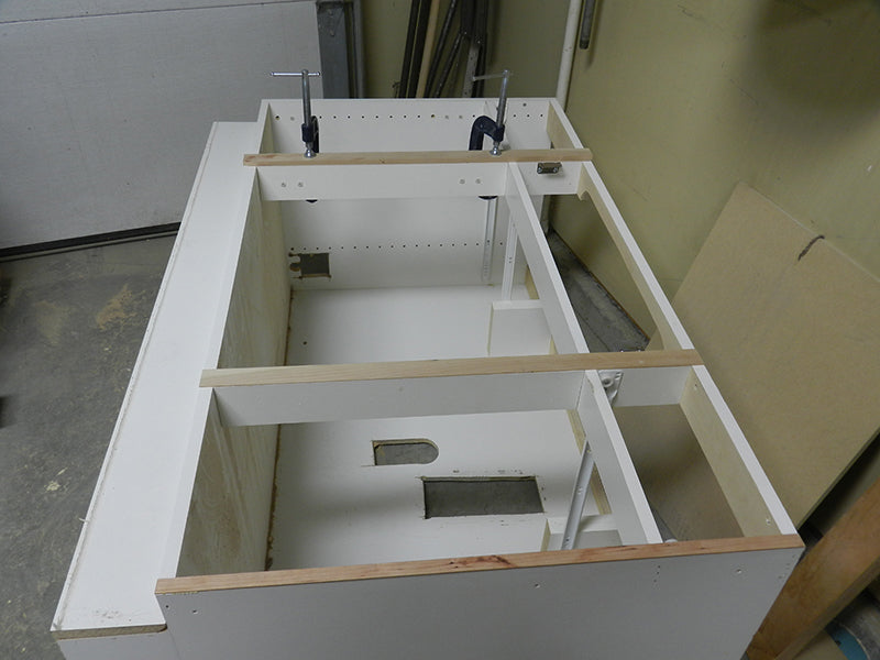 Bathroom cabinet internal rails refaced with 1/16 inch thick strips of cherry wood.