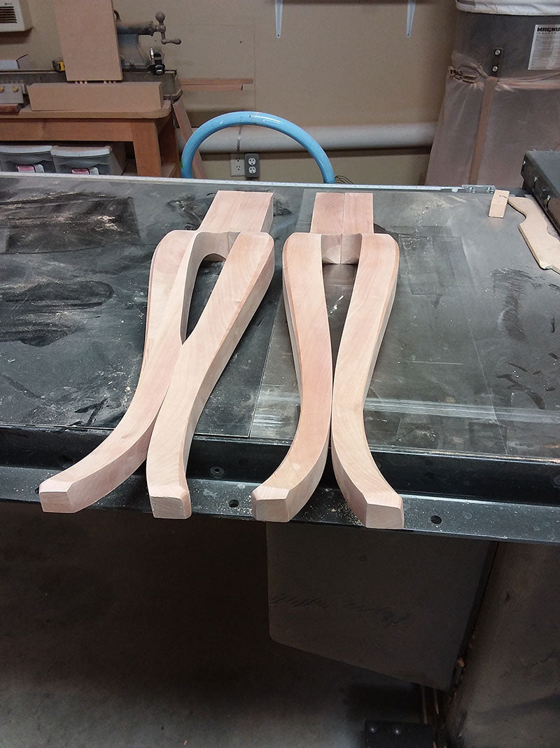 The cabriole legs used to build the bedroom table frame assembly, front legs on the right and rear legs on the left