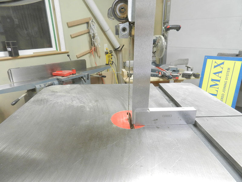 Checking the band saw blade is perpendicular to the cast iron saw base with a set square prior to cutting the cabriole leg shape