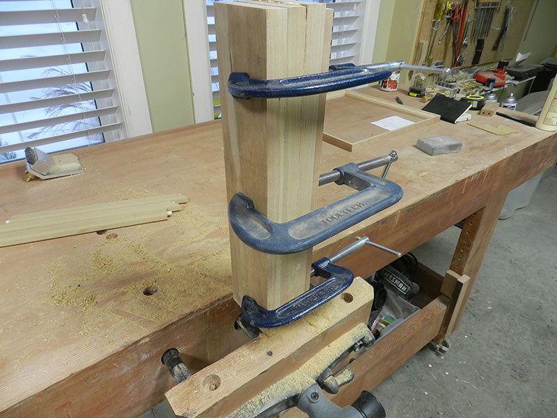 Three cherry work pieces glued and clamped together into one piece for construction of the Chippendale feet