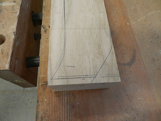 Curvature of footboard leg marked with pencil for cutting