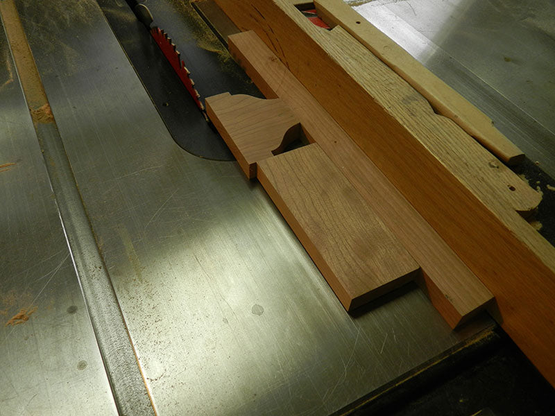 Decorative plate used to build the entryway table tie rail positioned in table saw for trimming using a jig for safety
