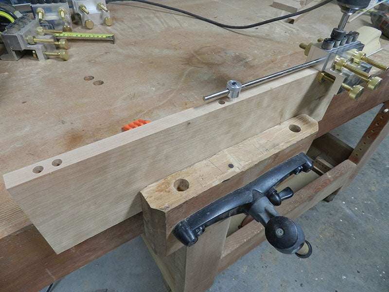 Dowelmax clamped to panel to drill dowel joint bores used to build the entryway table top assembly main section middle panel