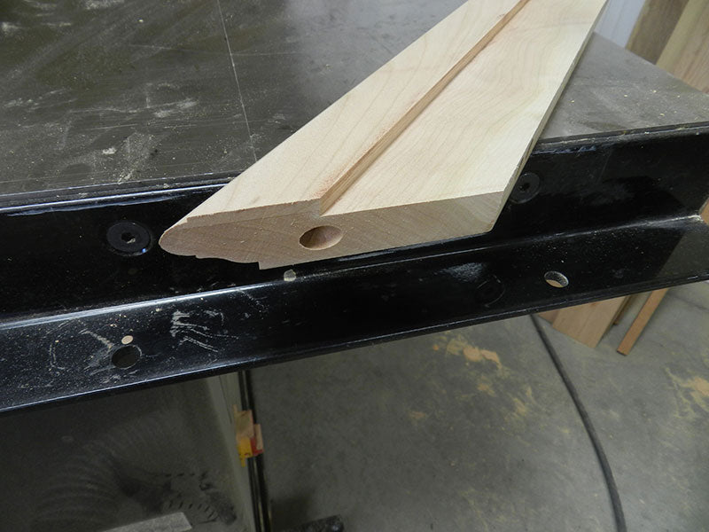 Dowel joint bore in mitered end of rail used to build the entryway table top assembly perimeter section