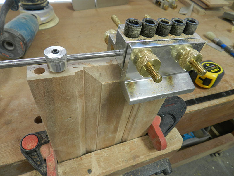 Dowelmax clamped to end panel to drill dowel bores in rails used to build entryway table frame assembly corner sections
