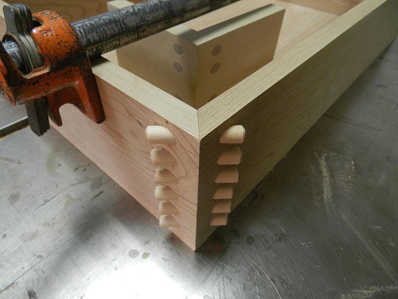 Doweled miter joint used to build entryway table drawer assembly front corner shown with dowels inserted and before trimming