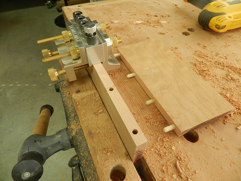 Dowelmax dowel jig with 1/8 spacer installed to center on half inch thick plant stand shelf