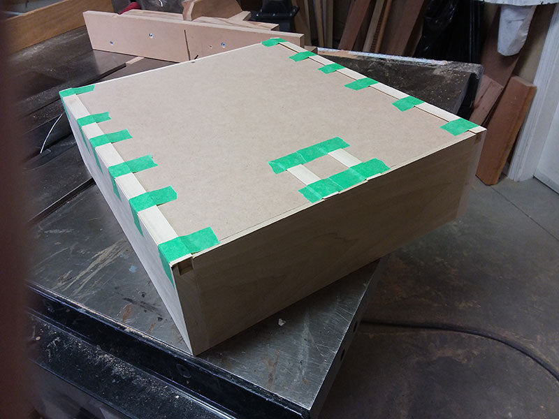 Slides positioned and taped to underside of entryway table drawer assembly