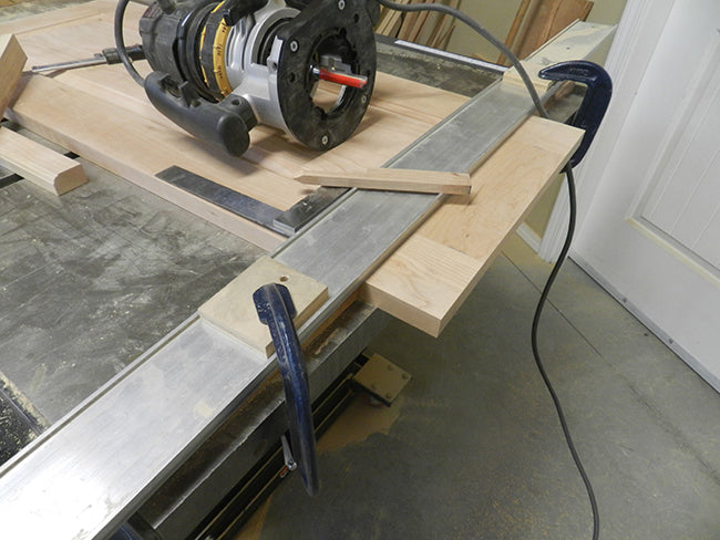 Edge of raised panel for footboard trimmed with router aligned to fence