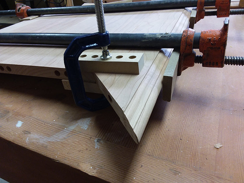 Method of clamping mitered rails used to build the bedside table top perimeter section