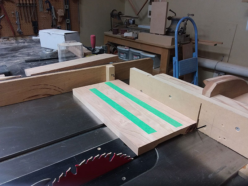 Painters tape laid along joint seams of rails and center panel used to build the bedside table frame side sections