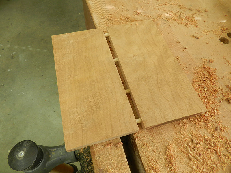 The plant stand lower shelf work piece cut into two and rejoined with 1/4 inch dowels to remove cup and bow