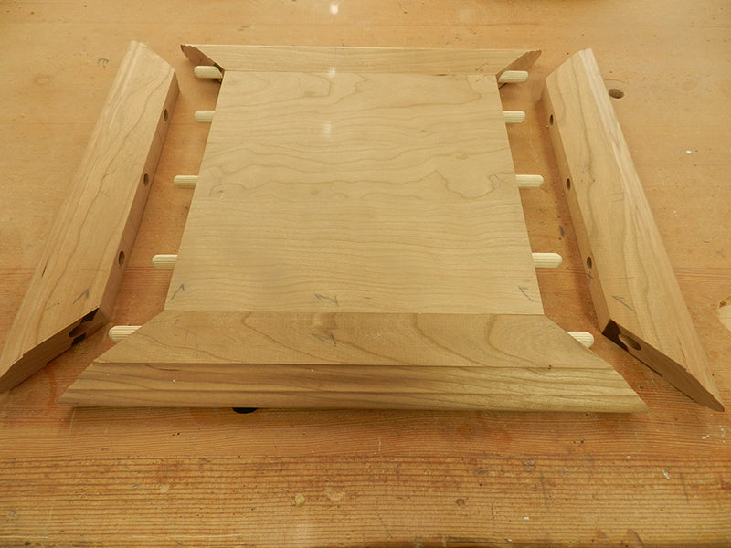 The plant stand top plate and mitered rails partially fitted to show the orientation of the dowel connections