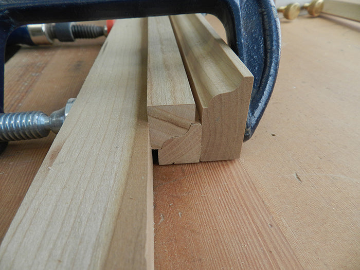Profiled mirror rails clamped together using ogee rail reversed