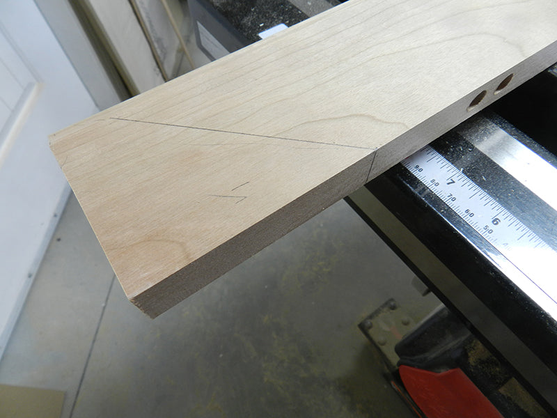 Scribed reference line for drilling into mitered edge rail before cutting miter