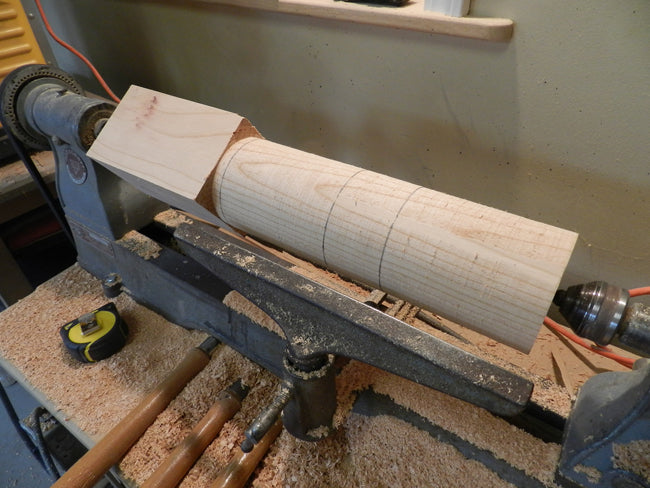 photo of 4 x 4 coffee table leg cylindrical section with scribe marks to locate sections of the turned design to be completed next