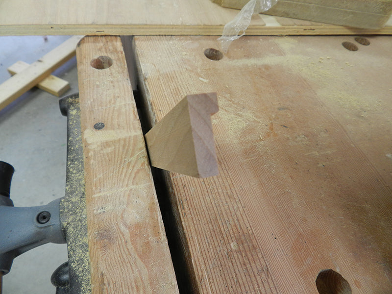 Shape of decorative moulding for plant stand top perimeter rails after being cut in table saw