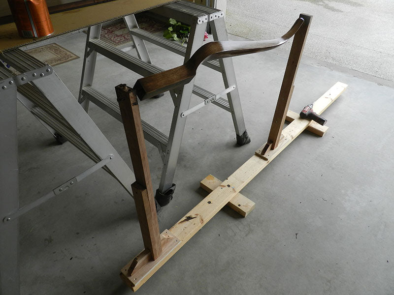 Stand with adjustable centers used to support and rotate the entryway table components for application of stain