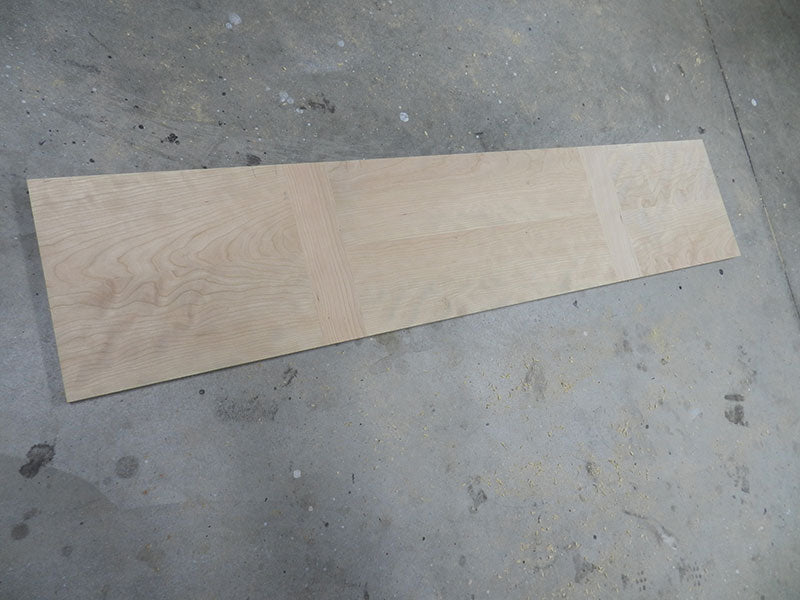 Glued and cured panels and rails used to build the entryway table top assembly main section ready for trimming
