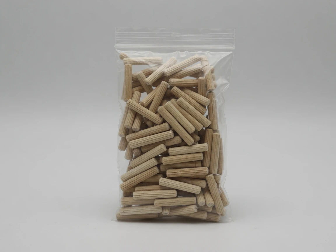 Retail bag of Dowelmax three-eighths by two-inch fluted hardwood dowel pins
